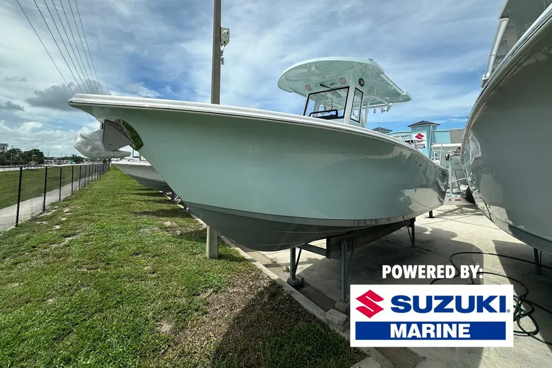 The Image of 2027 Sea Pro 265FLX Sandbar boat displayed outdoors, powered by Suzuki Marine. - 0