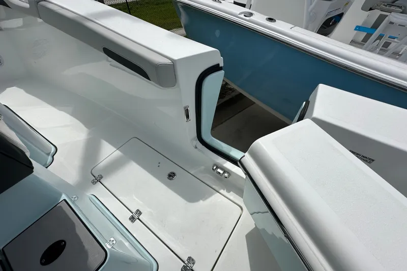Slide: The Image of 2027 Sea Pro 265FLX Sandbar boat interior with open side door and seating area. - 14