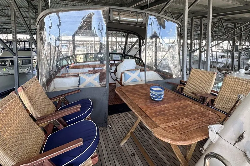 Slide: The Image of 1979 Hershine San Francisco yacht interior with wooden table and wicker chairs. - 13