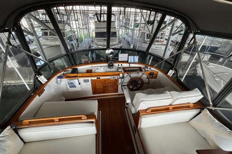 Slide: The Image of 1979 Hershine San Francisco yacht interior with wooden helm and white seating. - 15