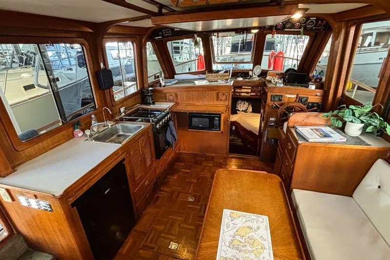 Slide: The Image of Interior of a 1979 Hershine San Francisco boat with kitchen and seating area. - 4
