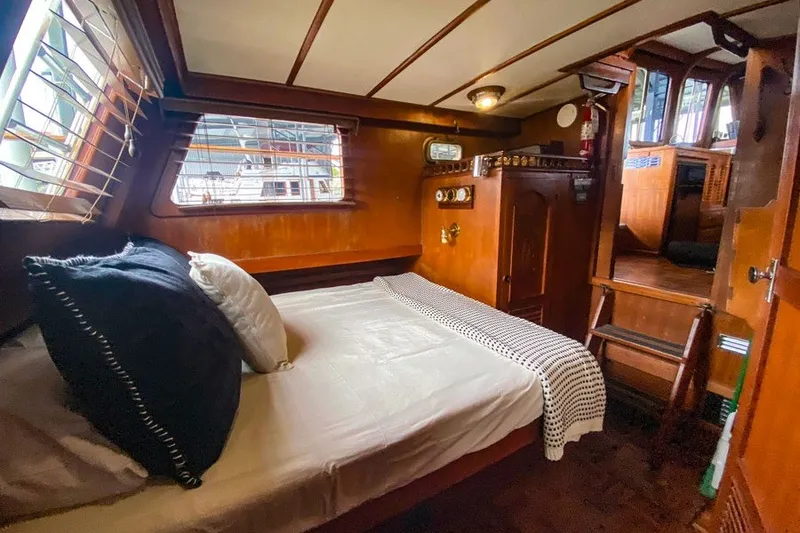 Slide: The Image of Cozy cabin interior of 1979 Hershine San Francisco boat with wooden decor and bed. - 9