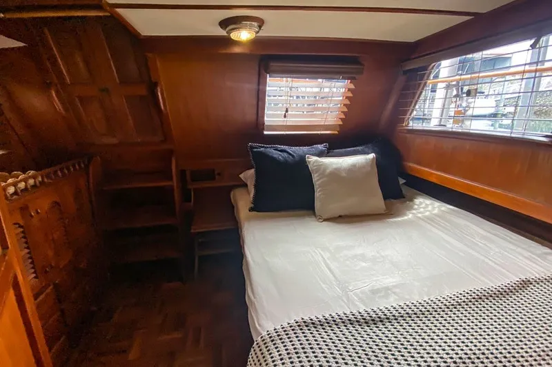 Slide: The Image of Cozy cabin bedroom in 1979 Hershine San Francisco boat with wooden interior and bed. - 8