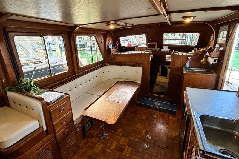 Slide: The Image of Interior of 1979 Hershine San Francisco yacht with wood finish and white seating. - 1