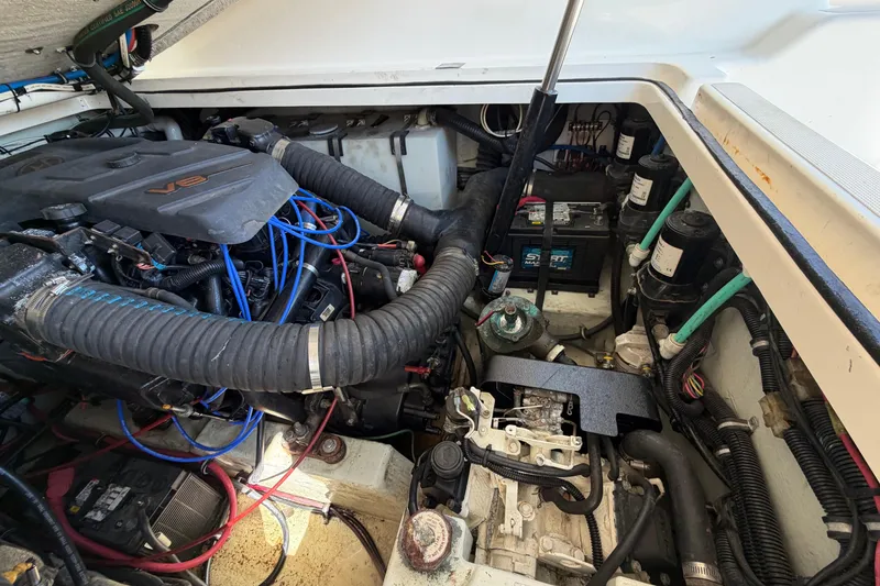 Slide: The Image of Engine compartment of a 2001 Pursuit 3000 Express boat, featuring a V8 engine. - 32