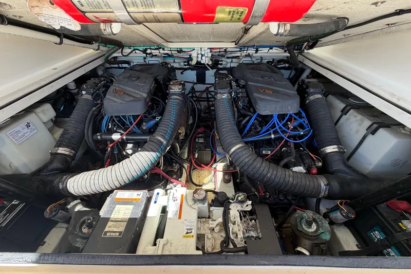 Slide: The Image of Engine compartment of a 2001 Pursuit 3000 Express boat, showcasing dual V8 engines. - 31