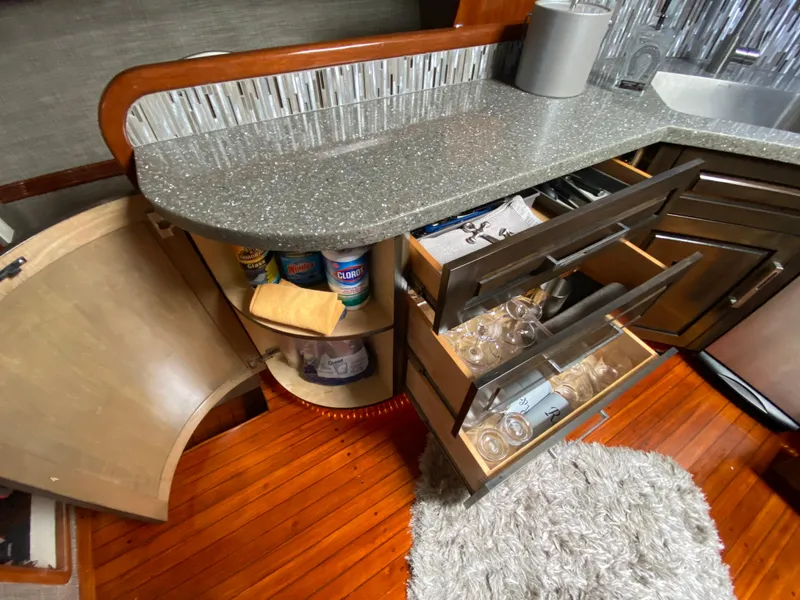 Slide: The Image of Kitchen area of a 1995 Mares 58 Power Cat with open cabinets and drawers. - 43