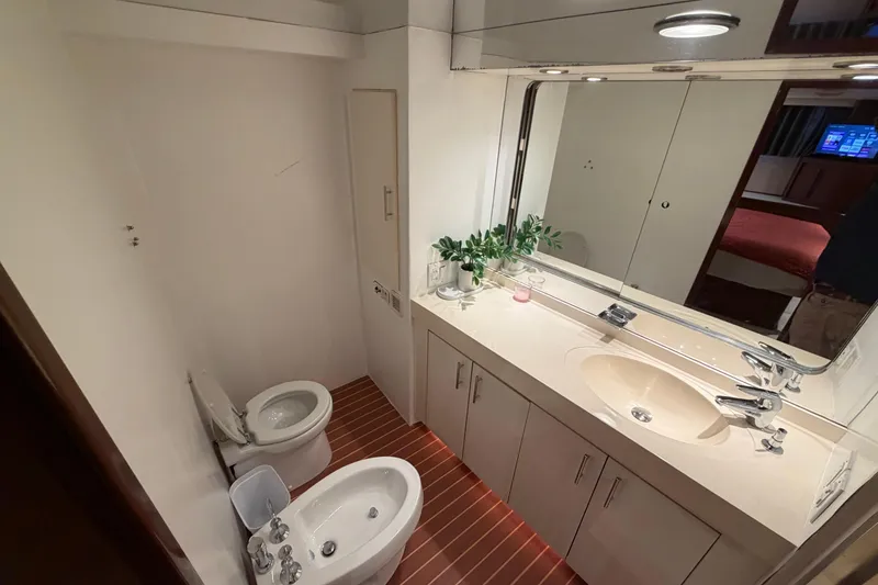 Slide: The Image of Luxurious bathroom in a 1991 Hatteras 70 Motor Yacht with modern fixtures and elegant design. - 81