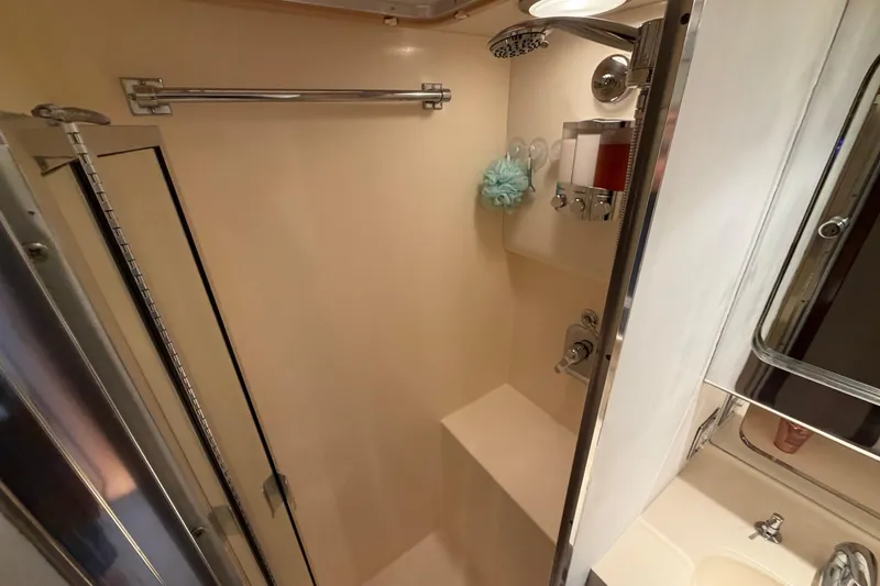 Slide: The Image of Shower area in 1991 Hatteras 70 Motor Yacht with modern fixtures and storage. - 89