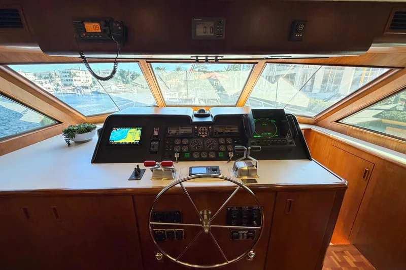 Slide: The Image of 1991 Hatteras 70 Motor Yacht helm with navigation equipment and panoramic windows. - 70