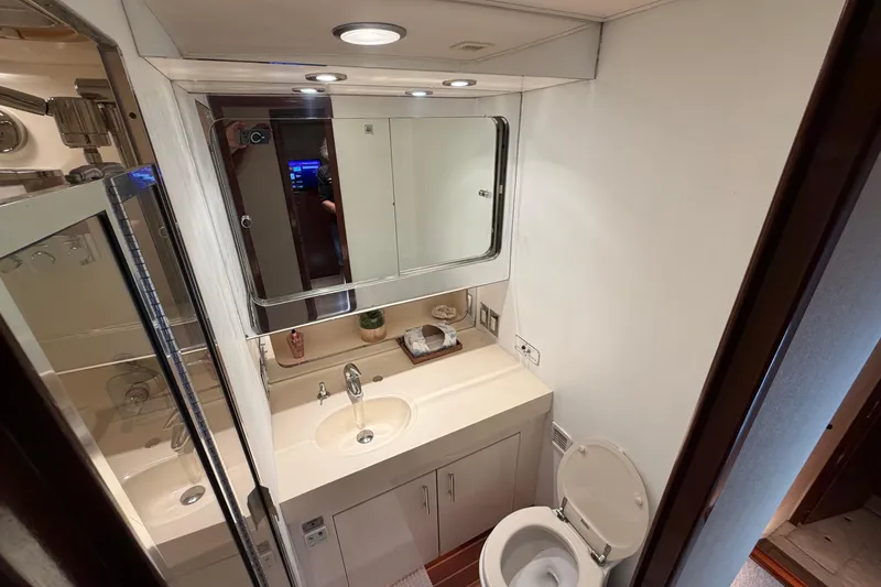 Slide: The Image of Bathroom interior of 1991 Hatteras 70 Motor Yacht with sink, mirror, and toilet. - 87