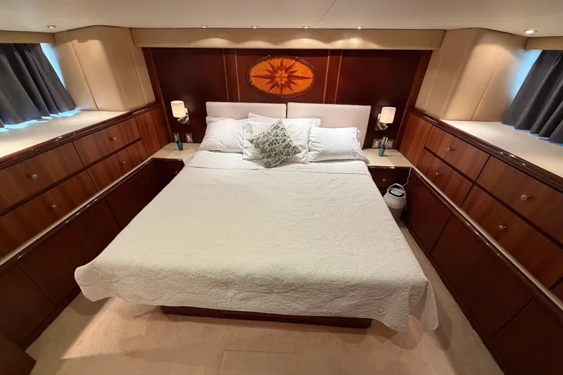 Slide: The Image of Luxurious bedroom in a 1991 Hatteras 70 Motor Yacht with elegant wood cabinetry. - 101