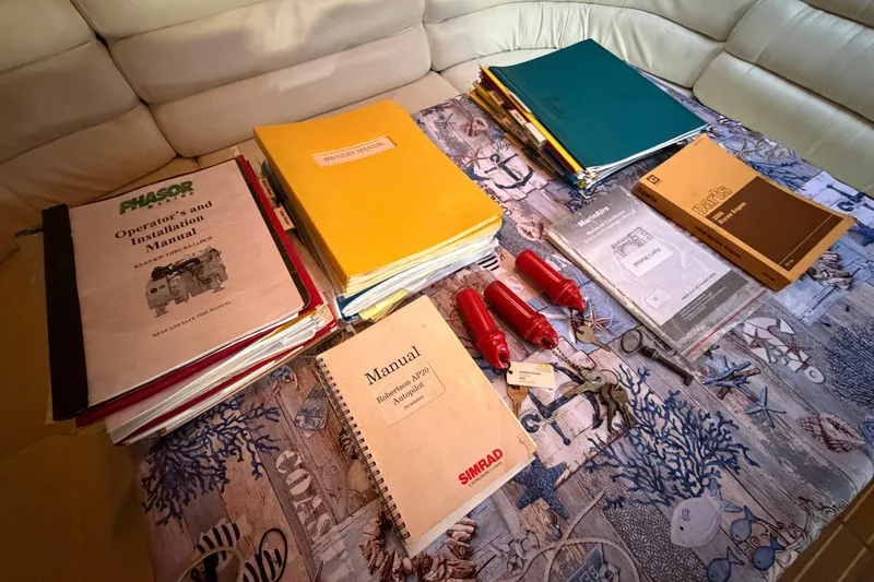 Slide: The Image of Manuals and documents on a table for a 1987 Hi-Star 55 Yacht Fisherman. - 51