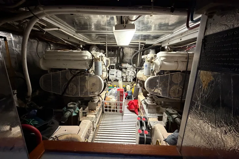 Slide: The Image of Engine room of a 1987 Hi-Star 55 Yacht Fisherman, featuring dual engines and maintenance tools. - 54