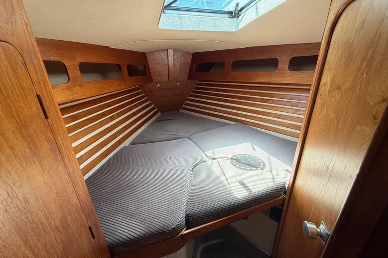 Slide: The Image of Cozy cabin interior of a 1987 Moody 376 sailboat with wooden accents and skylight. - 30