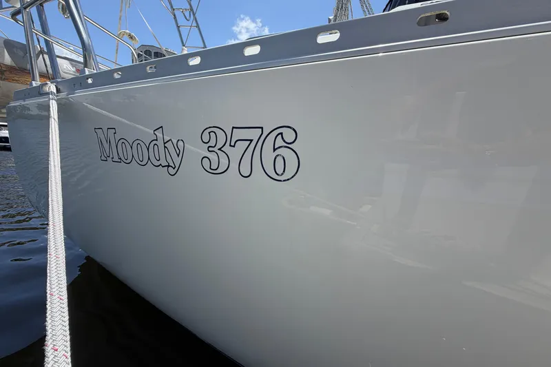 Slide: The Image of 1987 Moody 376 sailboat docked, showcasing sleek design and clear branding. - 5