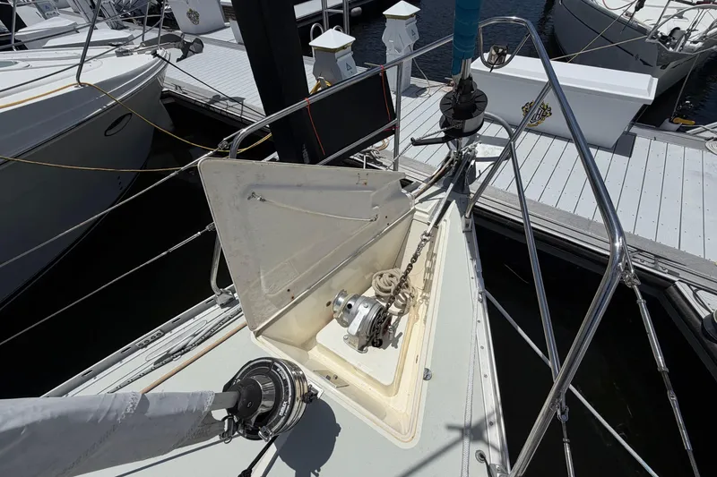 Slide: The Image of Bow of 1987 Moody 376 sailboat with anchor chain and winch at marina. - 7