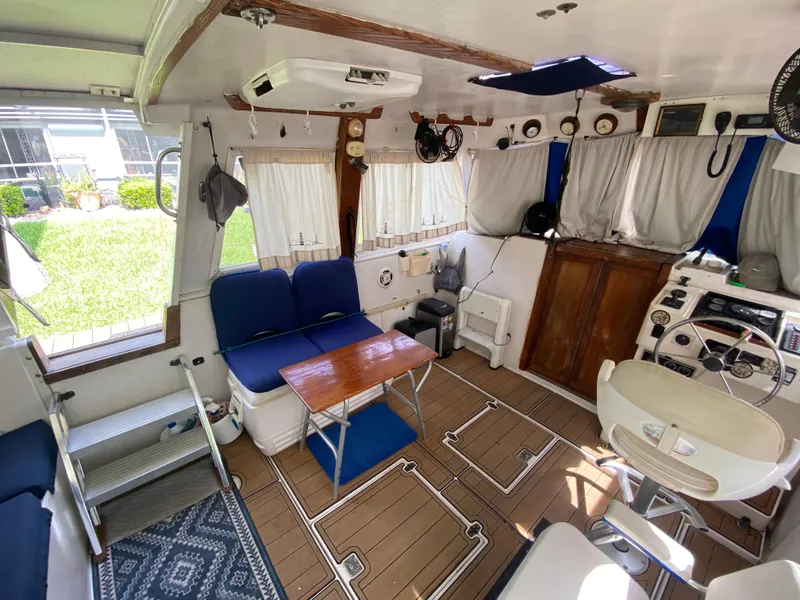 Slide: The Image of Interior of 1986 Albin 34 Family Cruiser with seating, table, and helm station. - 17