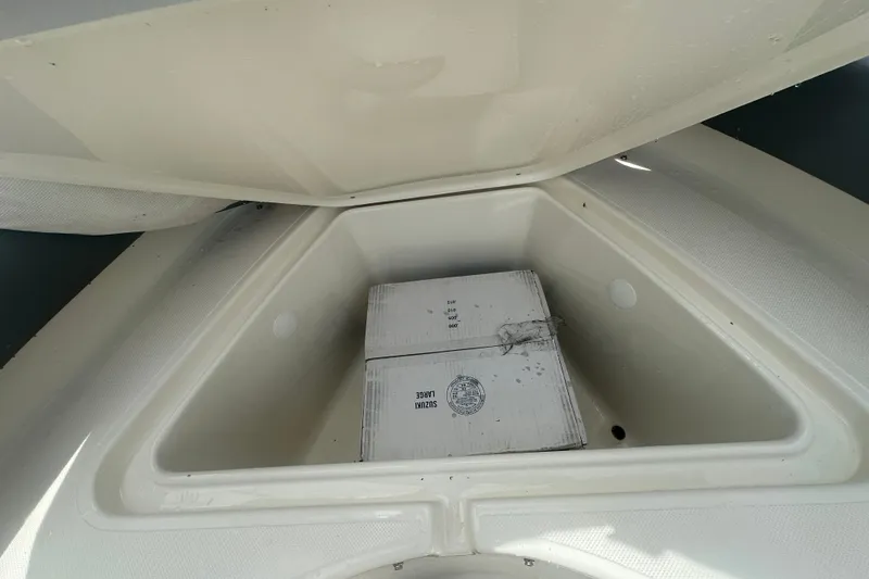 Slide: The Image of Storage compartment of 2027 Pioneer 180 Islander boat with a box inside. - 7