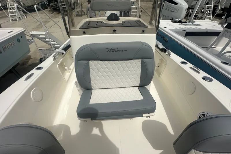 Slide: The Image of 2027 Pioneer 180 Islander boat interior with cushioned seating and modern design. - 6