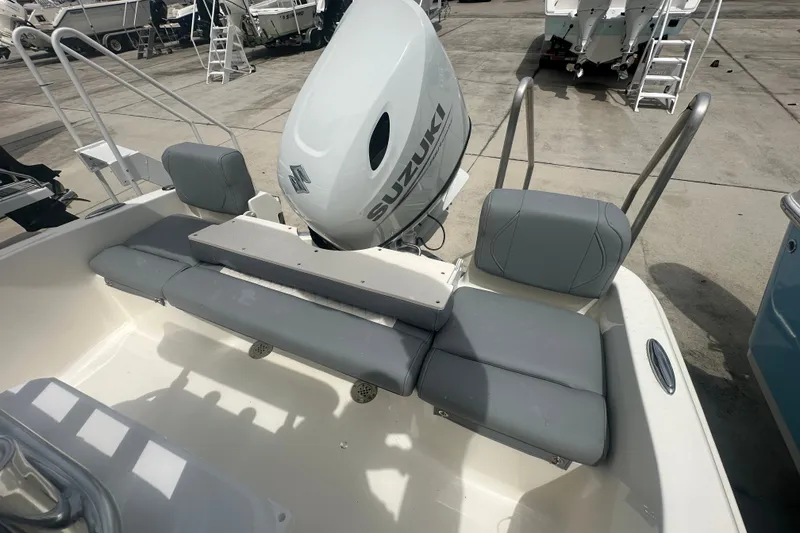 Slide: The Image of 2027 Pioneer 180 Islander boat with Suzuki outboard motor and gray seating. - 9