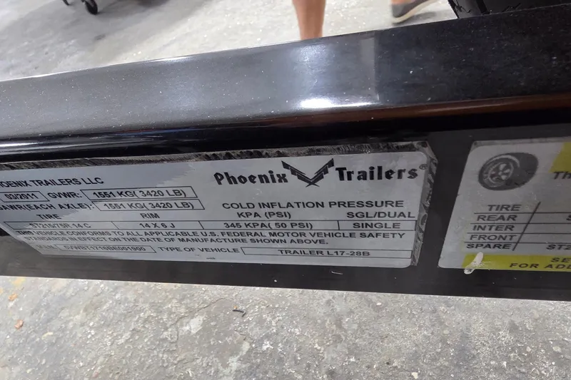 Slide: The Image of Label on Phoenix Trailers LLC showing specifications and tire pressure details. - 28