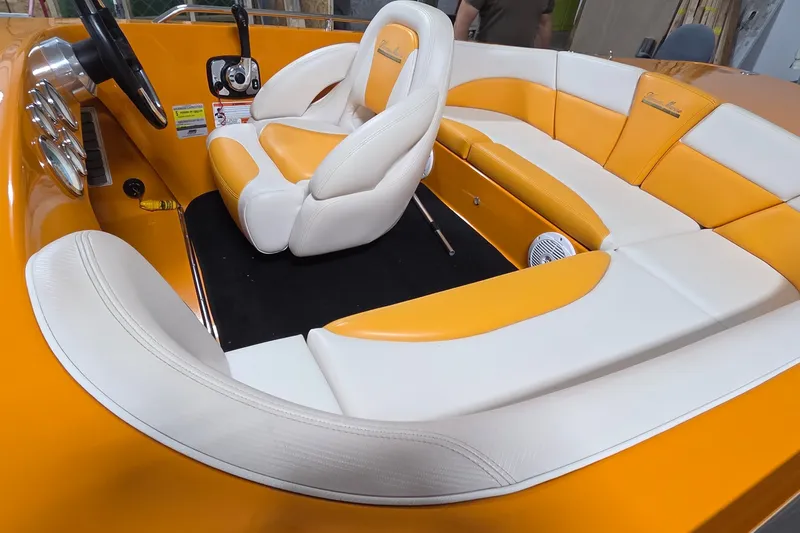 Slide: The Image of Orange and white interior of a 2012 Hornet Marine 17 boat, featuring plush seating. - 15