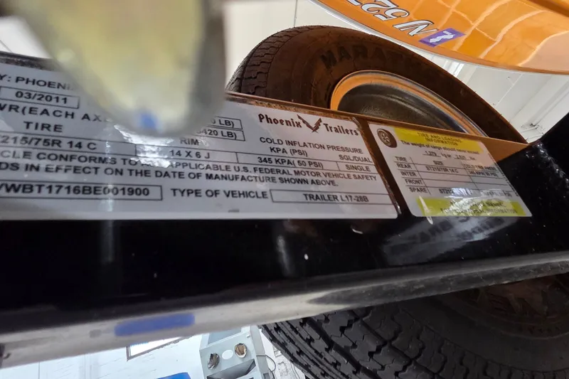 Slide: The Image of Trailer tire and specification labels on a Phoenix Trailers model, with visible tire details. - 29