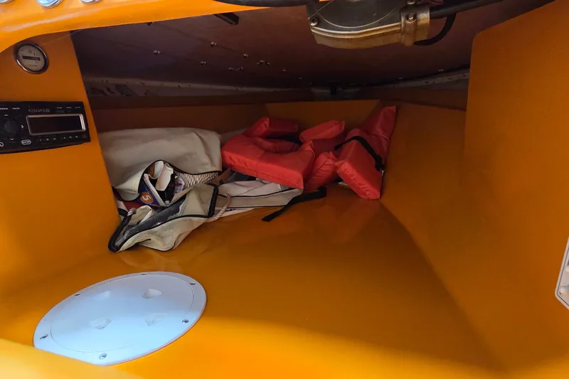 Slide: The Image of Interior of a 2012 Hornet Marine 17 boat with life jackets and storage. - 27