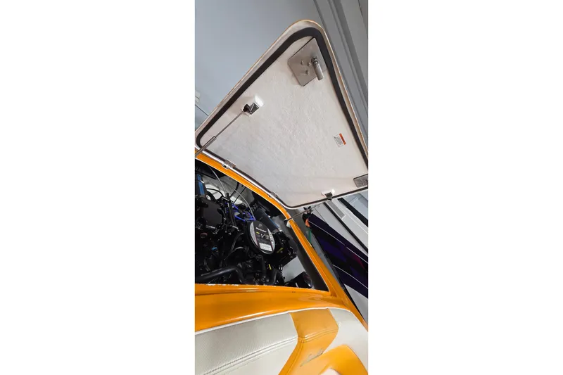 Slide: The Image of Open engine compartment of a 2012 Hornet Marine 17 boat, showcasing interior details. - 23