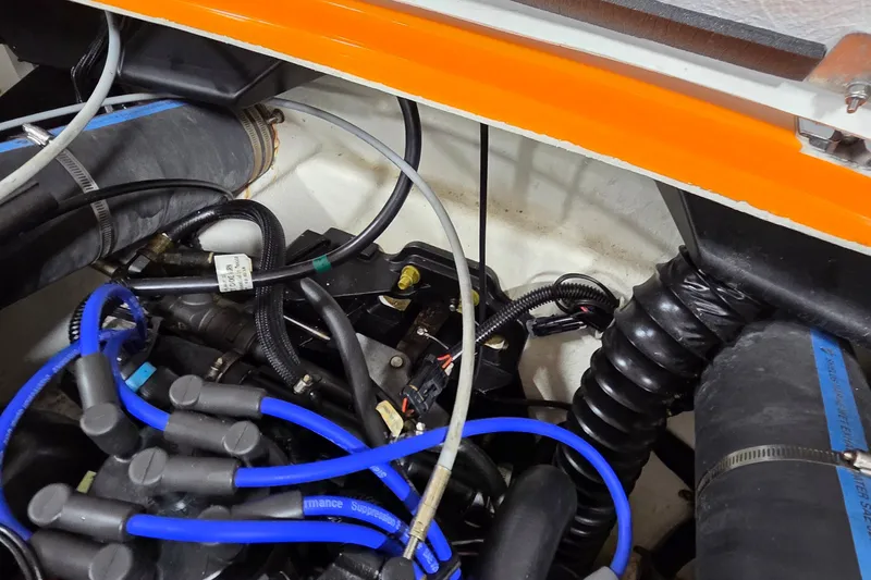Slide: The Image of Engine compartment of a 2012 Hornet Marine 17 boat with visible wiring and hoses. - 18