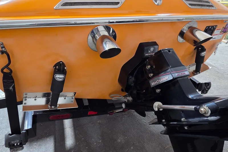 Slide: The Image of Rear view of a 2012 Hornet Marine 17 boat with MerCruiser engine and Lenco trim tabs. - 12