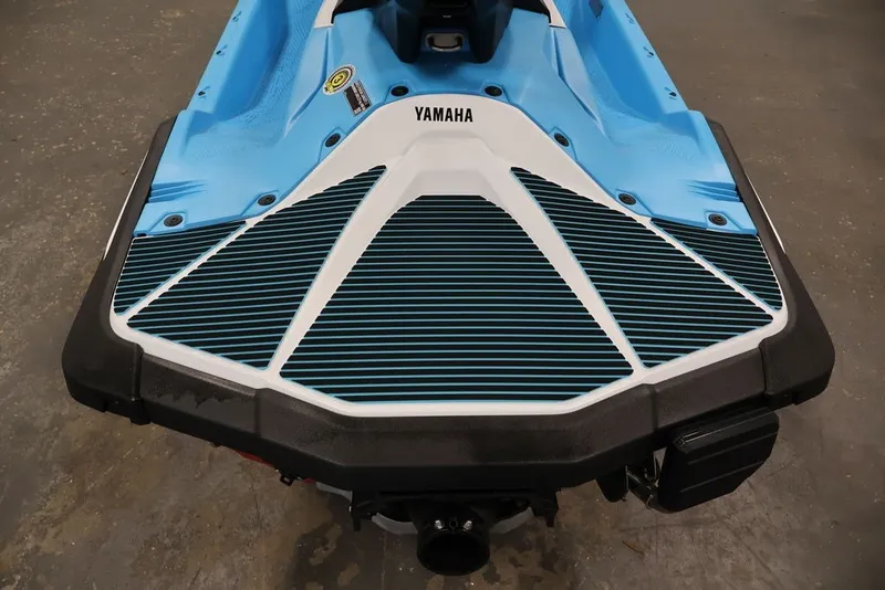 Slide: The Image of 2027 Yamaha WaveRunner JetBlaster DLX 3-Up, blue and white rear view on concrete floor. - 19