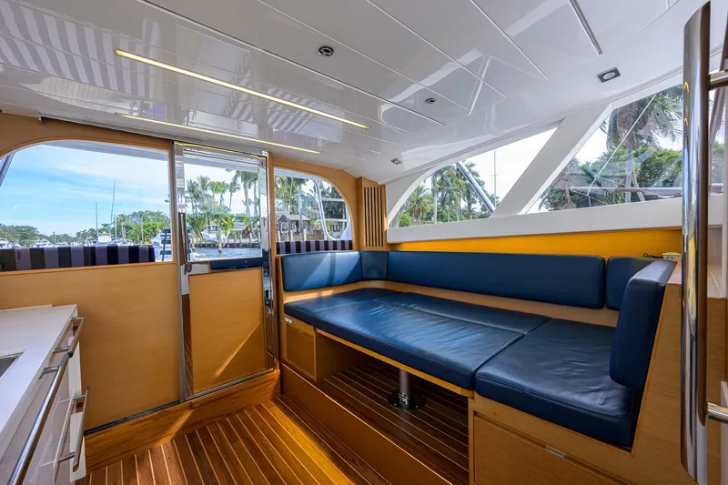Slide: The Image of Interior of 2018 Bertram 35 Flybridge yacht with blue seating and wooden accents. - 39