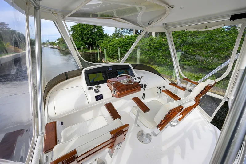 Slide: The Image of 2018 Bertram 35 Flybridge helm with dual seats and navigation equipment. - 23