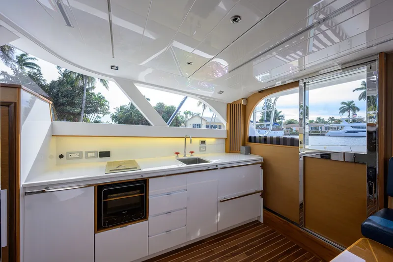 Slide: The Image of Luxurious interior of 2018 Bertram 35 Flybridge yacht with modern kitchen and scenic views. - 34