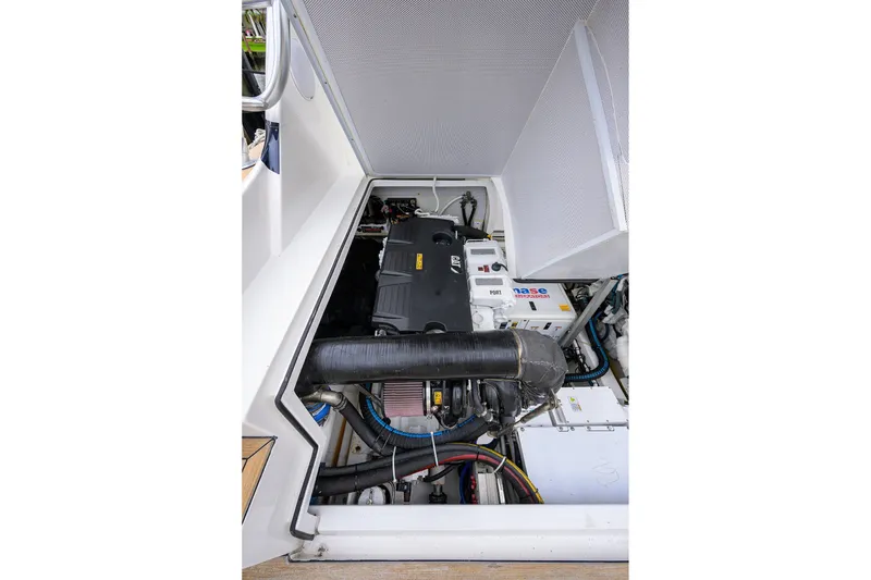 Slide: The Image of Engine compartment of a 2018 Bertram 35 Flybridge boat, showcasing mechanical components. - 50