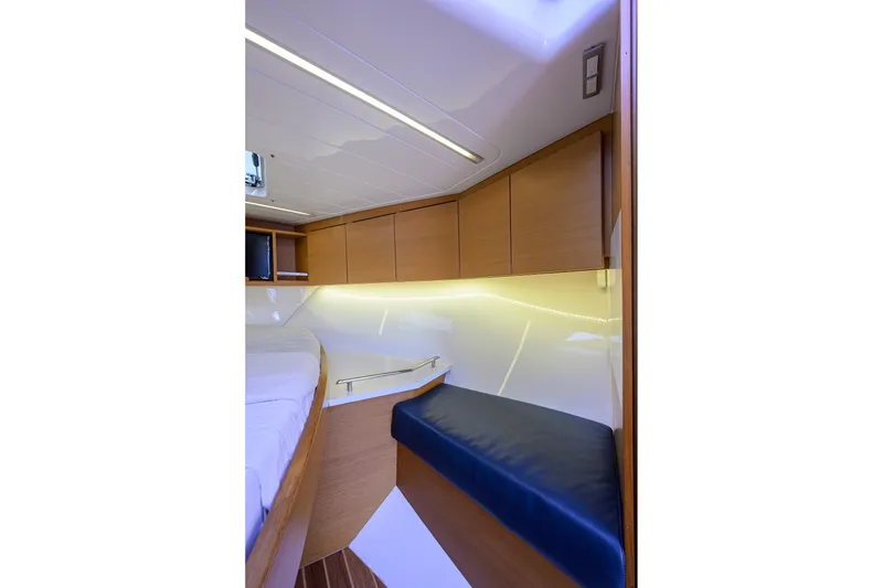 Slide: The Image of 2018 Bertram 35 Flybridge interior with wooden cabinets and blue cushioned seating. - 41