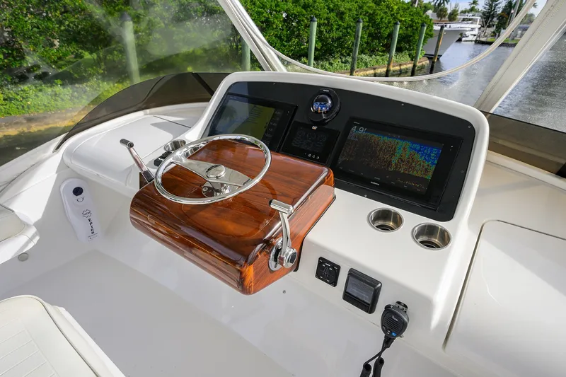 Slide: The Image of 2018 Bertram 35 Flybridge helm with modern controls and navigation displays. - 27