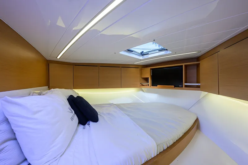 Slide: The Image of Luxurious cabin interior of 2018 Bertram 35 Flybridge yacht with cozy bed and modern amenities. - 43
