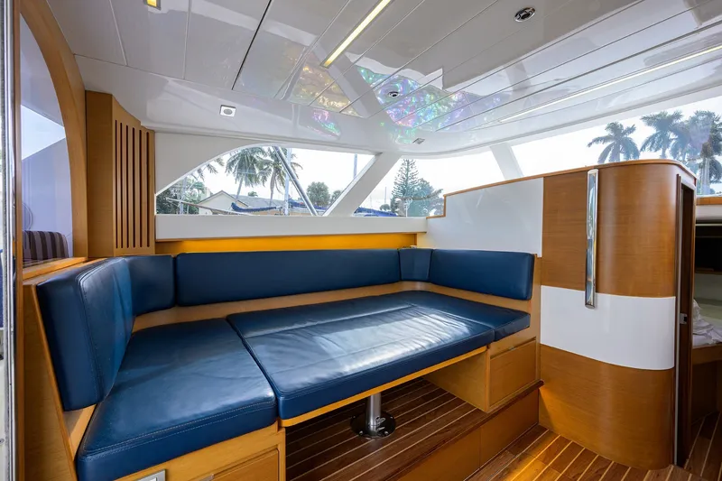 Slide: The Image of Luxurious interior of 2018 Bertram 35 Flybridge yacht with blue seating and wooden accents. - 37