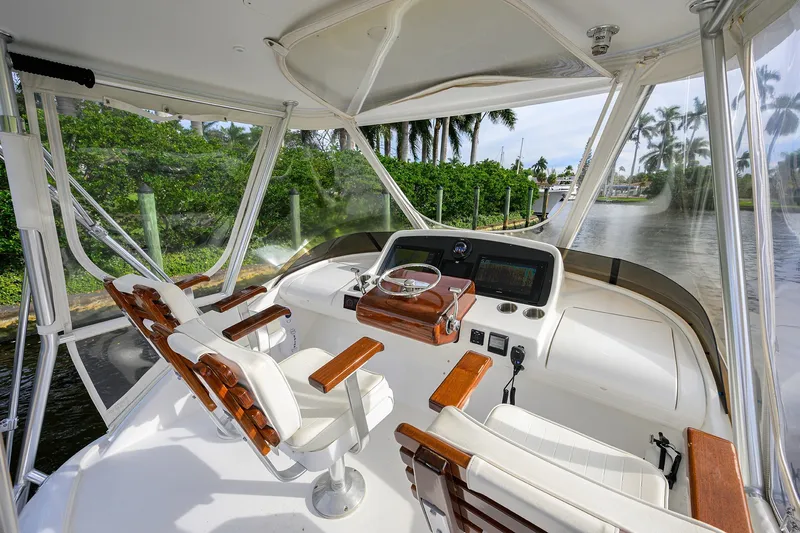 Slide: The Image of 2018 Bertram 35 Flybridge helm with luxurious seating and panoramic waterway view. - 25