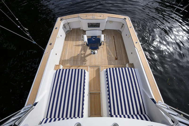 Slide: The Image of 2018 Bertram 35 Flybridge boat deck with striped seating, viewed from above. - 13