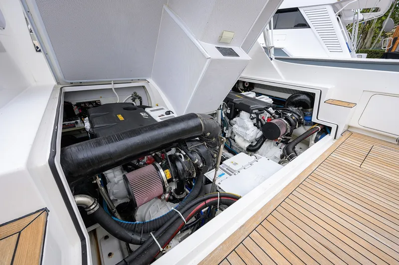 Slide: The Image of Engine compartment of a 2018 Bertram 35 Flybridge yacht, showcasing dual engines. - 49