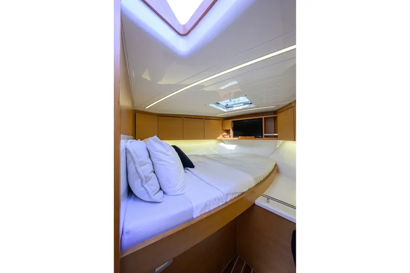 Slide: The Image of Luxurious cabin interior of 2018 Bertram 35 Flybridge yacht with skylight and cozy bedding. - 42