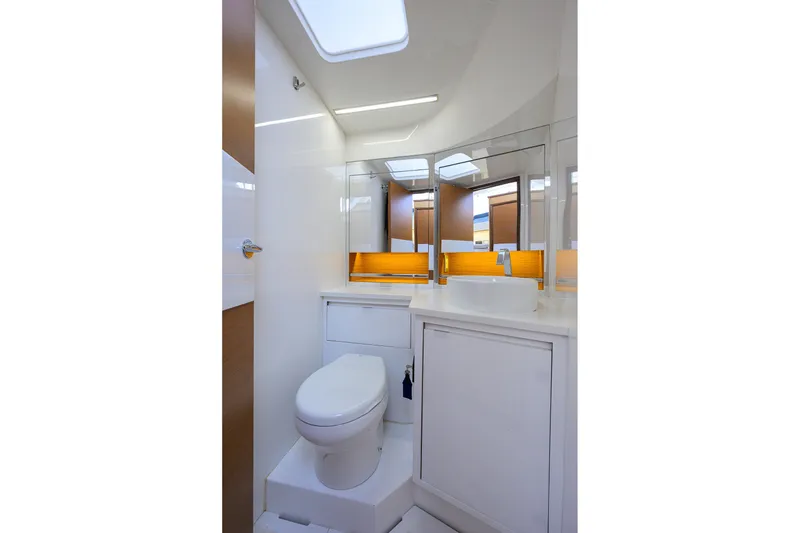 Slide: The Image of Modern bathroom interior on 2018 Bertram 35 Flybridge yacht, featuring sleek design and fixtures. - 45