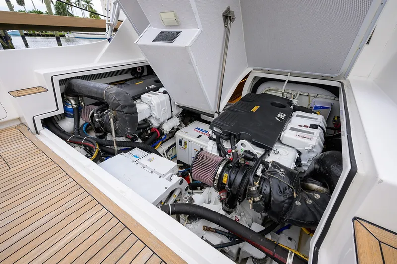 Slide: The Image of Engine compartment of a 2018 Bertram 35 Flybridge yacht, showcasing dual engines and components. - 47