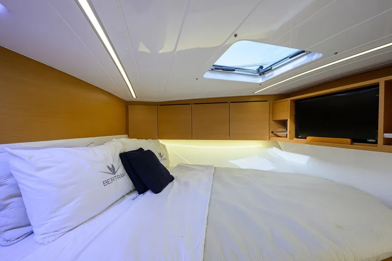 Slide: The Image of Luxurious cabin interior of 2018 Bertram 35 Flybridge yacht with skylight and TV. - 44