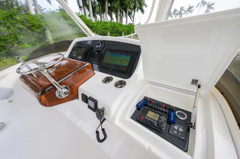 Slide: The Image of 2018 Bertram 35 Flybridge helm with advanced navigation and control systems. - 26