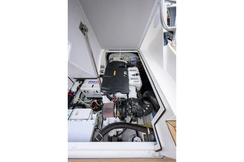 Slide: The Image of Engine compartment of a 2018 Bertram 35 Flybridge boat, showcasing mechanical components. - 51